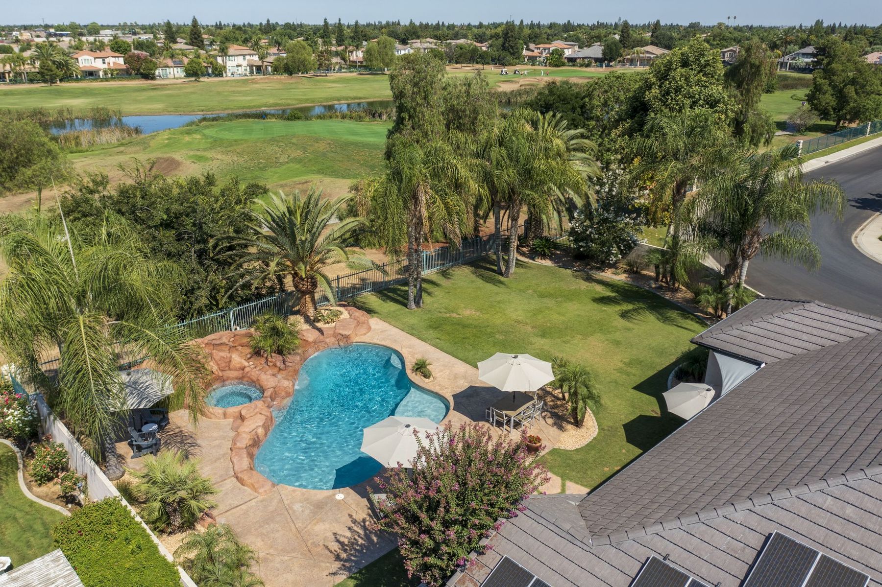 Drone photo of a backyard pool and golf course
